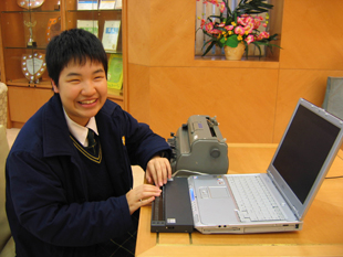 A Braille machine and a notebook computer installed with screen reading software